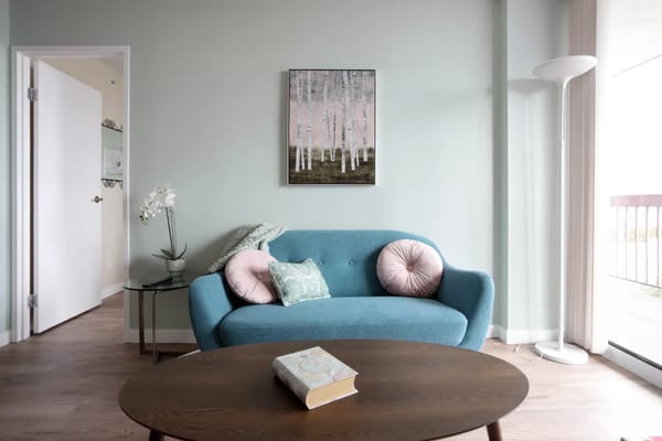 Cozy living room with a blue sofa and art on the wall