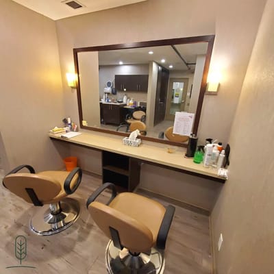 Interior view of a beautician area with chairs and mirror