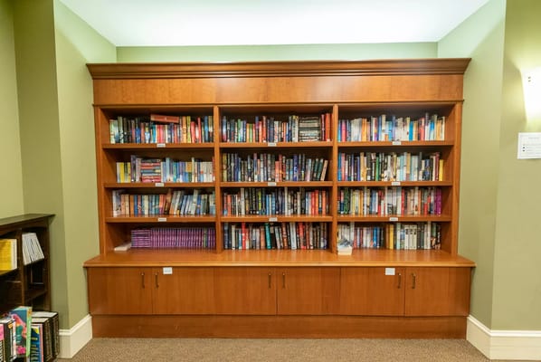 Bookshelf filled with various titles in a cozy interior