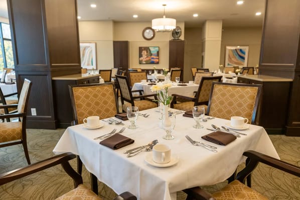 Dining area set for a meal with flowers
