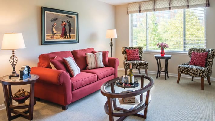 Bright and inviting living room with red couch and leopard print chairs