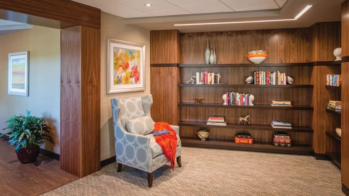 A cozy reading nook with bookshelves and a comfortable chair