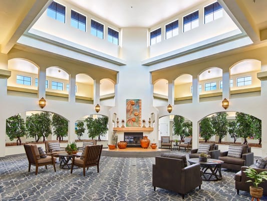Bright and spacious lobby with seating areas and greenery