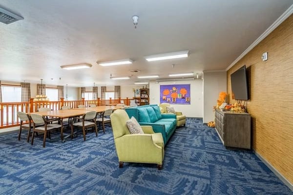 Bright and spacious common area with seating and dining table