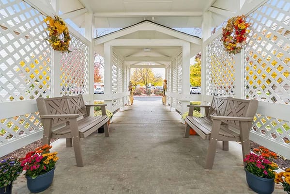 Covered walkway with benches and flower pots