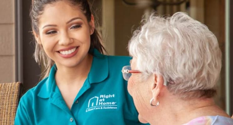 Caregiver interacting with a senior resident indoors