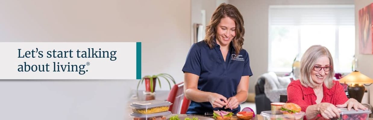 Caregiver assisting a resident with meal preparation