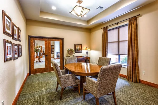 An interior common area with a round table and chairs