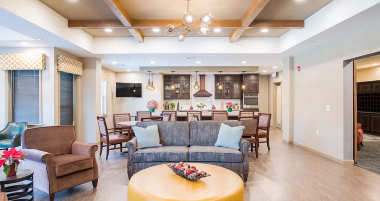 Cozy lounge area with sofa, chairs, and dining tables