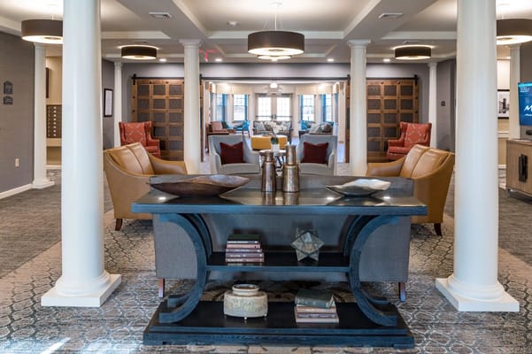 Cozy lounge area with comfortable seating and decorative table in River Mills Assisted Living.