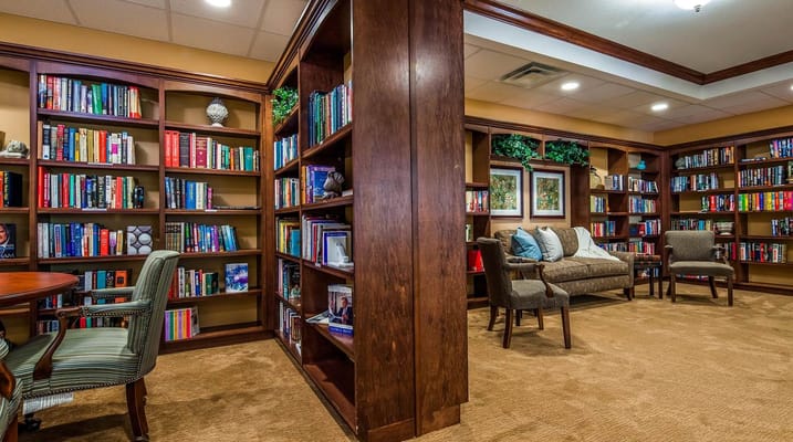 Interior view of the library with bookshelves and seating area.