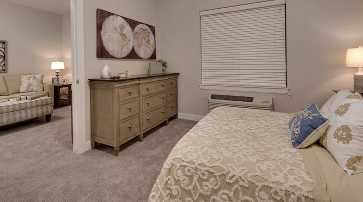 Cozy bedroom with decorative bedding and wooden dresser