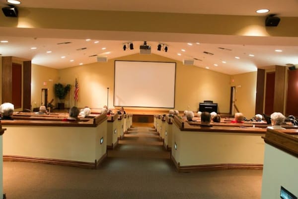 Residents watching a movie in the theater room.