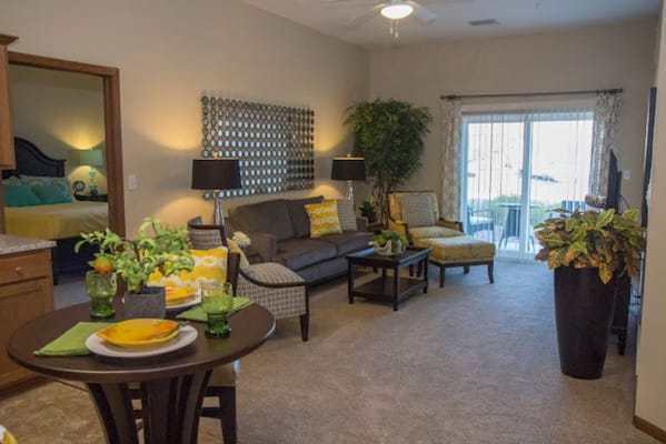 Inviting living room with sofa, dining table, and patio access