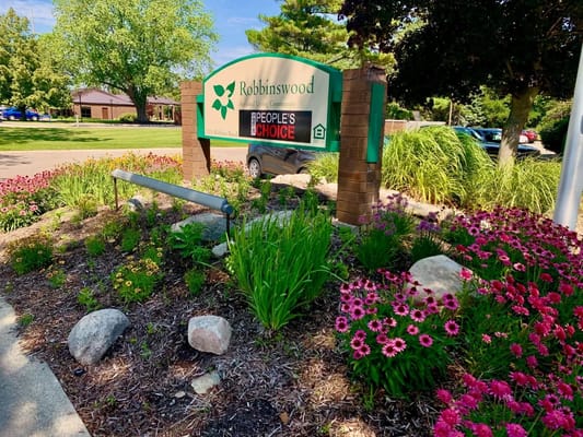 Signage for Robbinswood Assisted Living Community with flowers