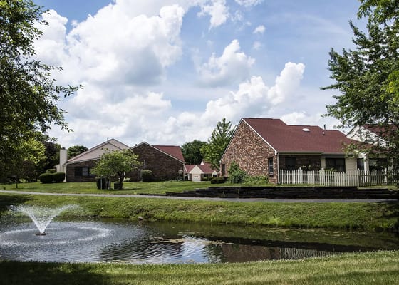 Exterior view of senior living buildings by a pond