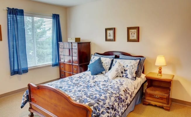 Well-appointed bedroom with a wooden bed and blue curtains