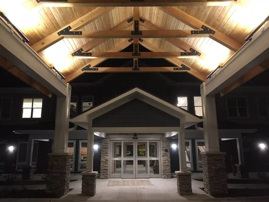 Entrance of a senior living facility with wooden beams