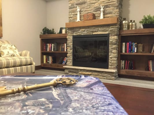Cozy common area with a fireplace and bookshelves