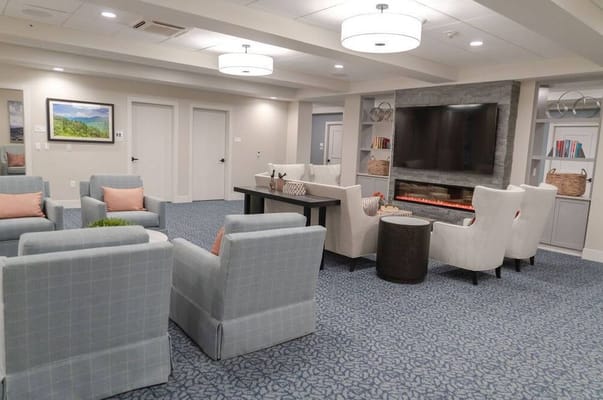 A cozy living room with comfortable seating and a modern fireplace.