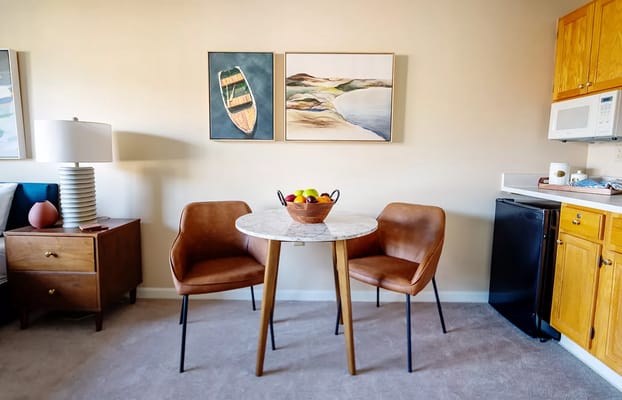 Cozy dining area with a marble table and two chairs at Rockland Place.