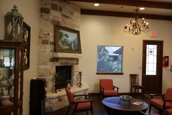 Living room with stone fireplace and seating area