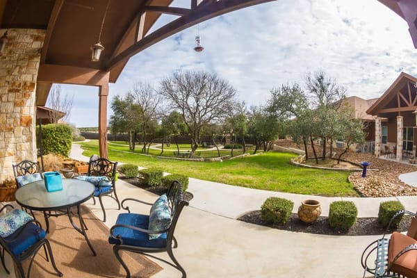 Patio seating area overlooking lush green grounds