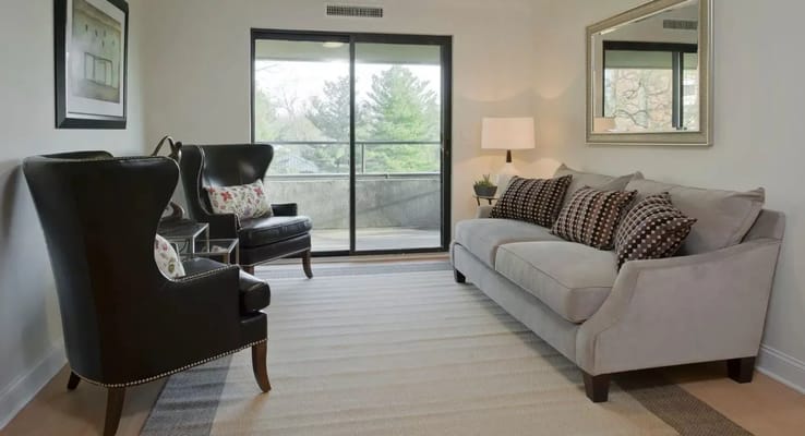 Bright common area with seating and access to outdoor space