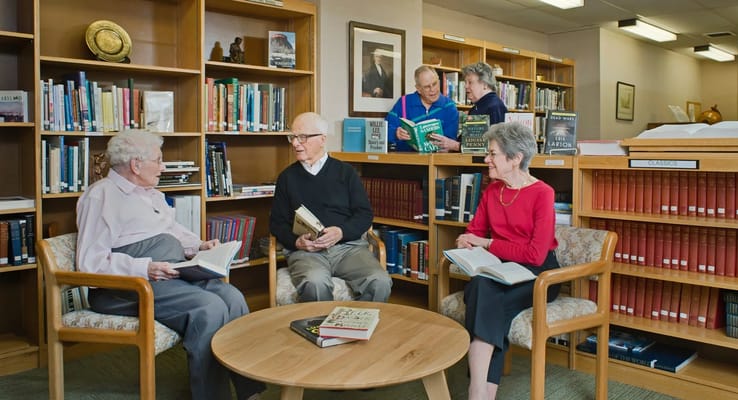 Residents reading in a common area library