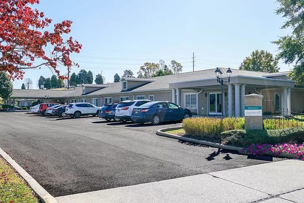 View of the parking area and entrance of Rolling Meadows Place