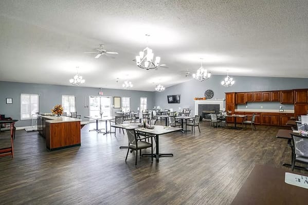 Bright common area with dining tables and a kitchenette