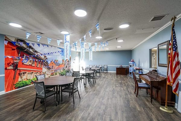 Bright common area decorated with Oktoberfest banners and tables.
