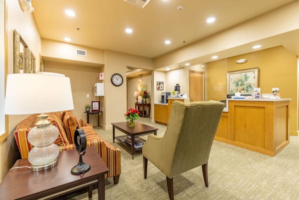 Interior view of a common area with seating and a reception desk