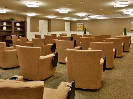 A spacious community room with comfortable chairs arranged for gatherings.