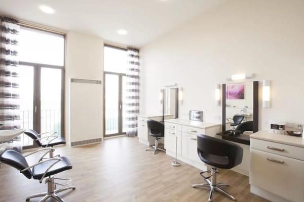 Modern hair salon with styling stations and large windows
