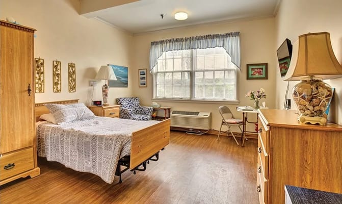 A cozy resident room with bed and furniture