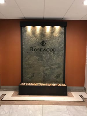 Interior stone wall feature with facility name