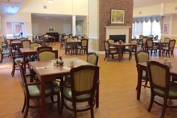 Dining room with tables and chairs for residents