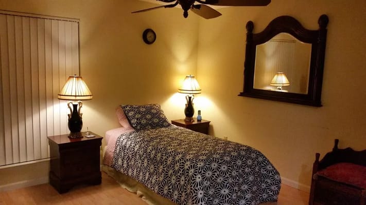 Bedroom with a bed, bedside tables, and lamps