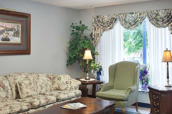 Cozy common area with floral couch and armchair