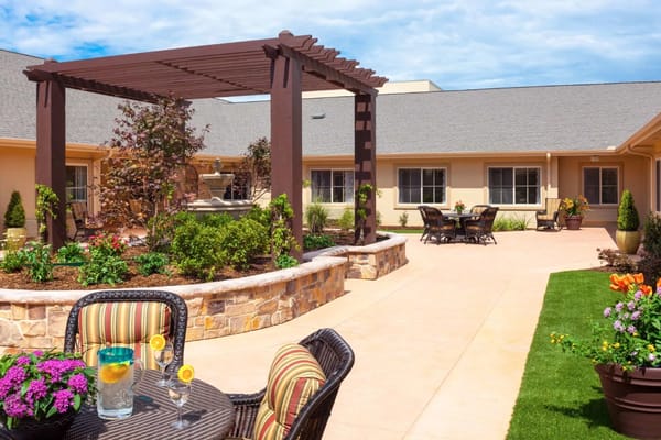 Beautiful courtyard with seating and garden at Saddlebrook Oxford Memory Care.