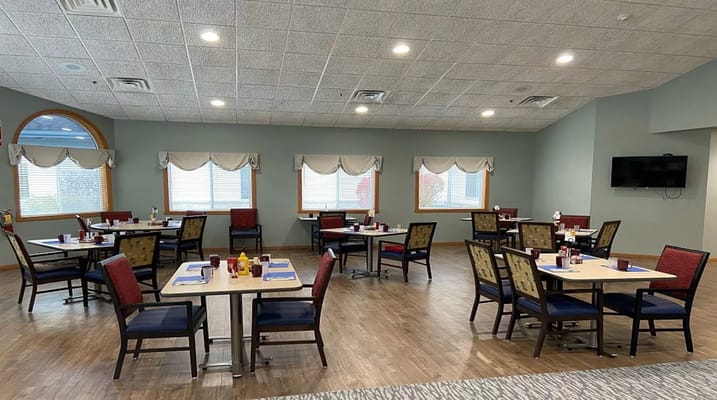 Bright dining room with tables and chairs set for meals