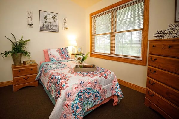 Cozy bedroom with colorful bedding and natural light