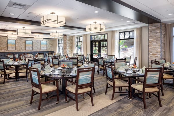 Spacious dining room with tables set for a meal