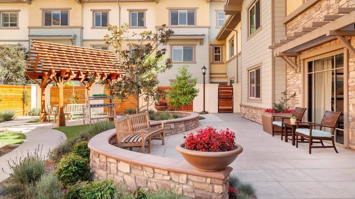 Beautiful outdoor patio with benches and landscaping.