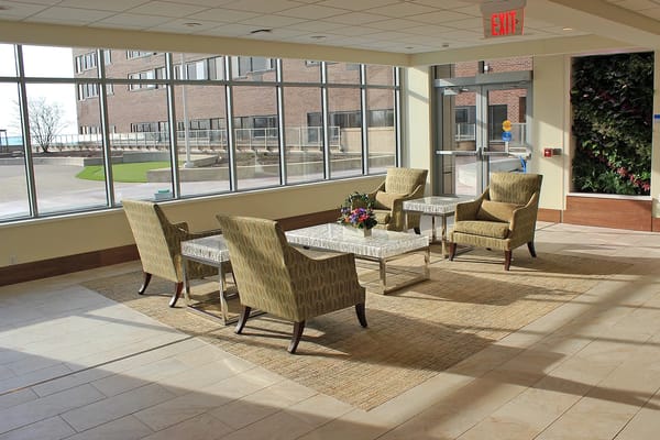 Bright common area with seating and large windows