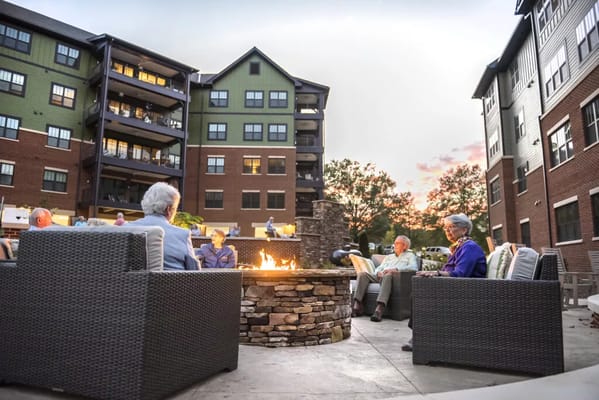 Seniors gathered around a fire pit at Salemtowne Retirement Community