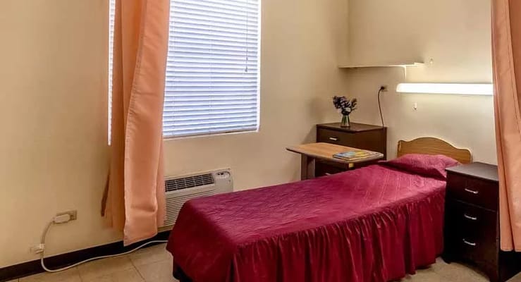Bedroom with a single bed and a side table.