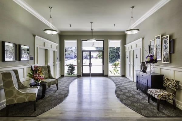 Spacious lobby with seating and floral arrangements