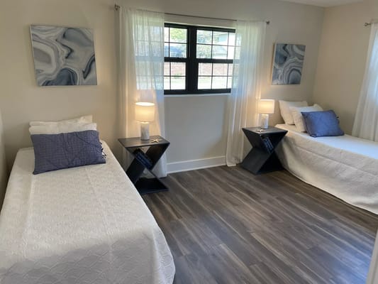 Bright and inviting bedroom with two beds and modern decor